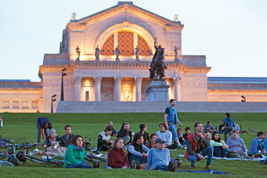 WashU students and staff sitting on Art Hill in Forest Park