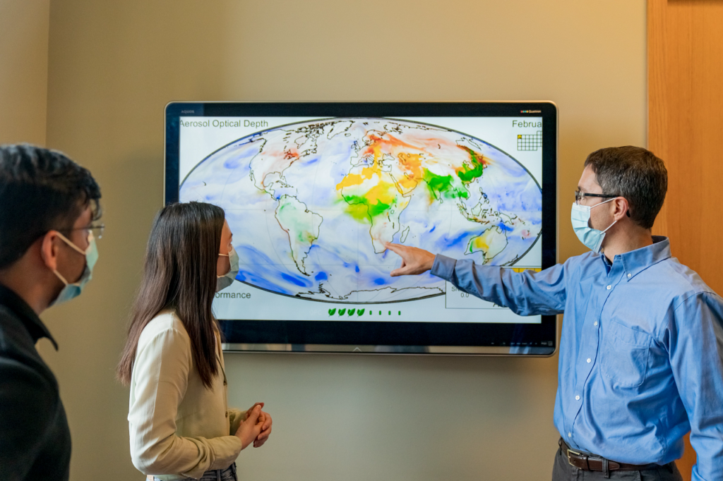 Inderjeet Singh, (L-R) Dandan Zhang, and Randall Martin looking at digital map