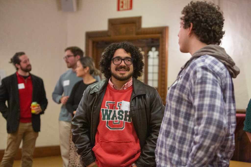 Carlos Ayma Gonzalez, McKelvey Engineering Class of 2025, chats with another attendee