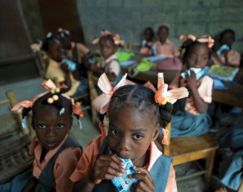 Students eating supplemental snacks in pouches