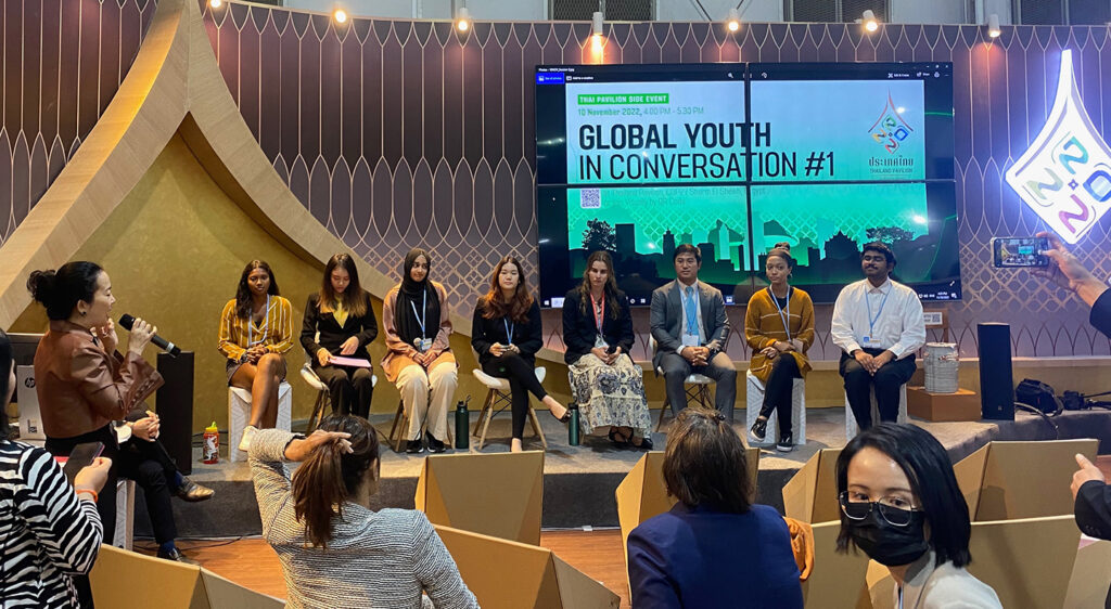 Students sit on a stage during a panel discussion